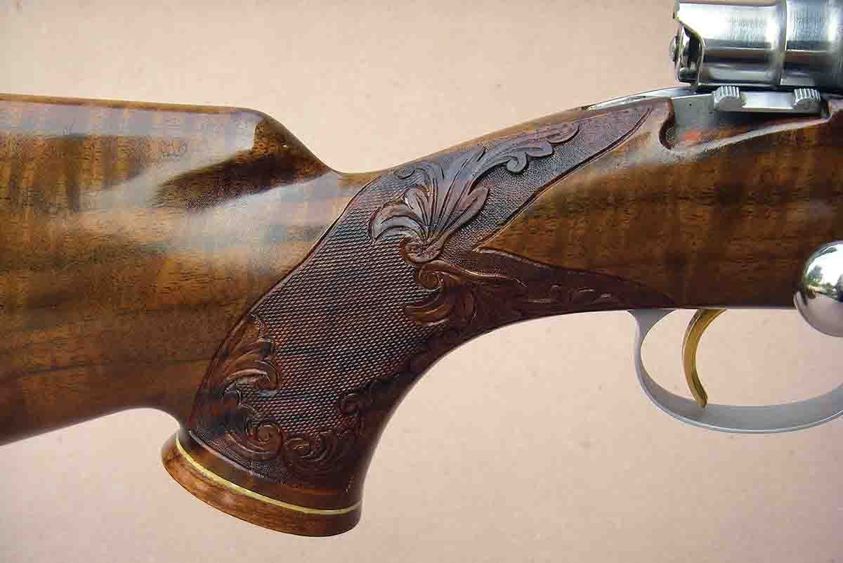 An Olympian Grade rifle is shown with a hand-carved and checkered stock.